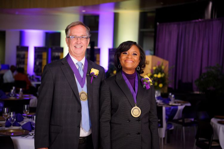 Kip Knight and Joeaneane Smith wearing HOD medals at banquet.