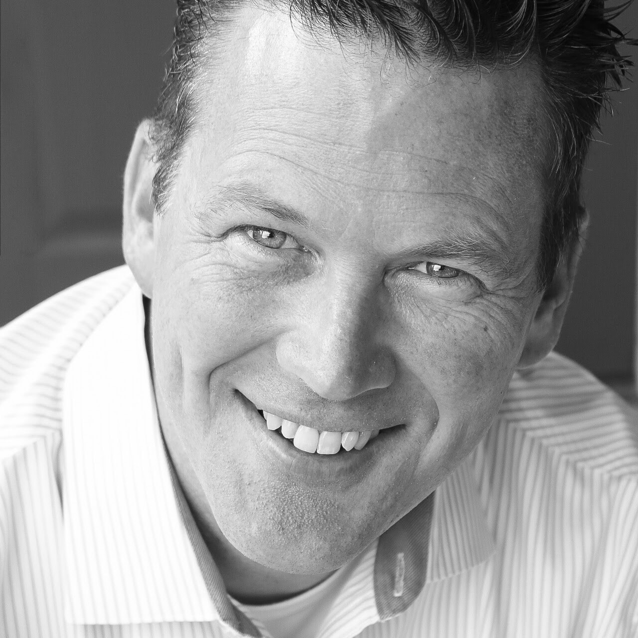 Black and white photo of Henry Hays. He is smiling and you can see only his face.