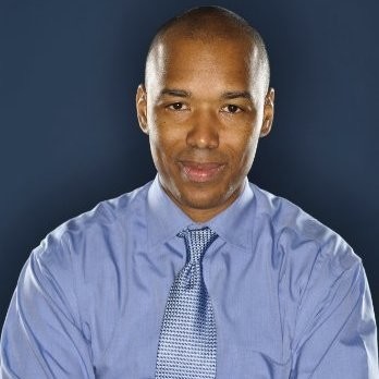 Marcus Brown headshot. Man in a light blue buttonup shirt.