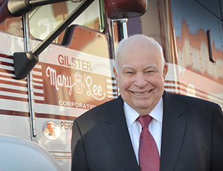 Tom Welge standing in front of a large shipping truck